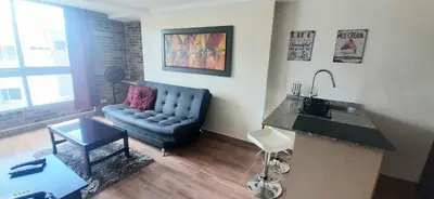 a living room with a blue couch and a table at New comfortable Laureles Apartment Great location! in Medellín