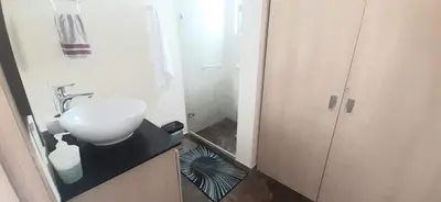 a small bathroom with a sink and a mirror at New comfortable Laureles Apartment Great location! in Medellín