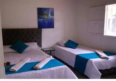 two beds in a room with towels on them at Hermosa Finca Con Piscina y Jacuzzi in El Peñol