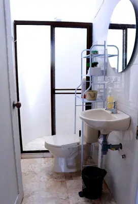 a bathroom with a toilet and a sink and a mirror at Hermosa Finca Con Piscina y Jacuzzi in El Peñol