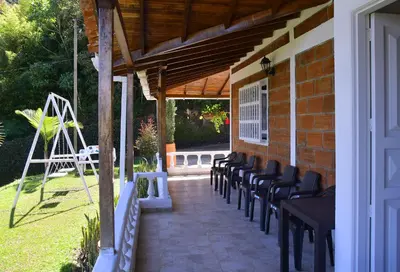 a group of chairs sitting on a patio at Hermosa Finca Con Piscina y Jacuzzi in El Peñol
