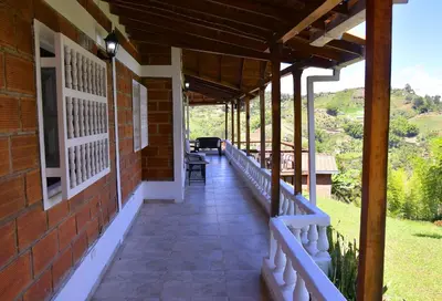 a porch of a house with a view at Hermosa Finca Con Piscina y Jacuzzi in El Peñol