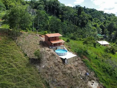 an aerial view of a house on a hill at Cabaña cerca a hacienda Nápoles in Doradal