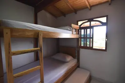 two bunk beds in a room with a window at Cabaña cerca a hacienda Nápoles in Doradal