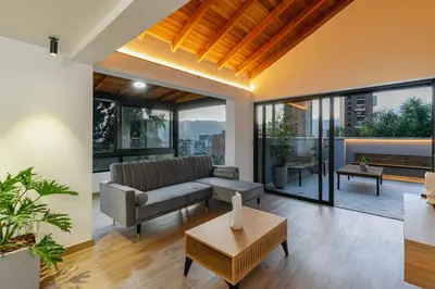 a living room with a couch and a table at B3 4BR Poblado Penthouse wit AC and Jacuzzi in Medellín