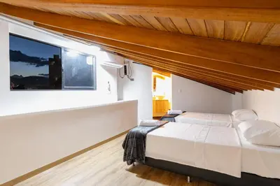 a bedroom with a large bed and a window at B3 4BR Poblado Penthouse wit AC and Jacuzzi in Medellín