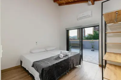 a bedroom with a large bed and a balcony at B3 4BR Poblado Penthouse wit AC and Jacuzzi in Medellín