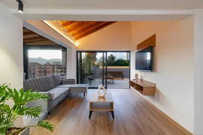 a living room with a couch and a table at B3 4BR Poblado Penthouse wit AC and Jacuzzi in Medellín