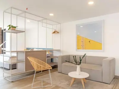 a living room with a couch and a table and chairs at Modern Loft in Laureles in Medellín
