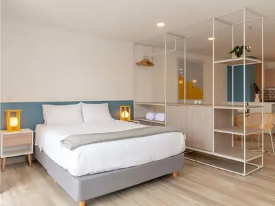 a bedroom with a large bed with glass shelves at Modern Loft in Laureles in Medellín