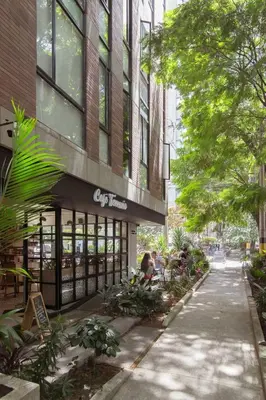 a building with a lot of plants in front of it at Modern Loft in Laureles in Medellín