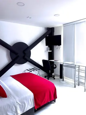 a bedroom with a red bed and a desk at Mini Loft in Envigado in Envigado