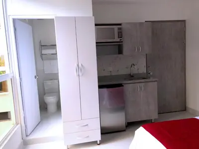 a small kitchen with a sink and a microwave at Mini Loft in Envigado in Envigado