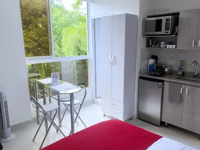 a kitchen with a table and a small table with chairs at Mini Loft in Envigado in Envigado