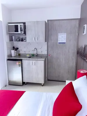 a kitchen with a refrigerator and a sink and a microwave at Mini Loft in Envigado in Envigado