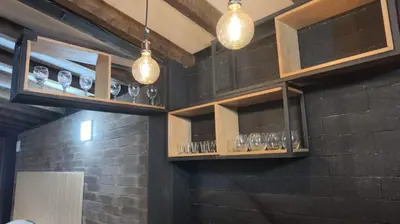 a bar with glasses and lights on a brick wall at Espectacular Cabaña en Rionegro Antioquia, vista paisajes in Rionegro