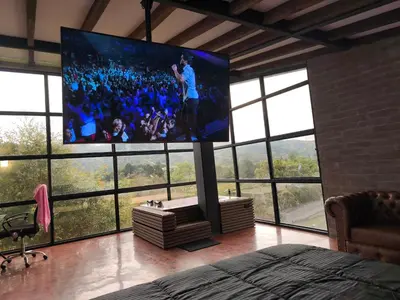 a room with a large tv in a room with windows at Espectacular Cabaña en Rionegro Antioquia, vista paisajes in Rionegro