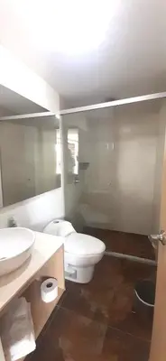 a bathroom with a white toilet and a sink at Mingle with the beautiful Paisas, Perfect location in Medellín