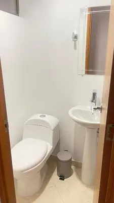 a white bathroom with a toilet and a sink at Aparta estudio muy bien ubicado in Medellín