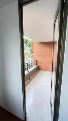 an open door to a balcony with a brick wall at Aparta estudio muy bien ubicado in Medellín