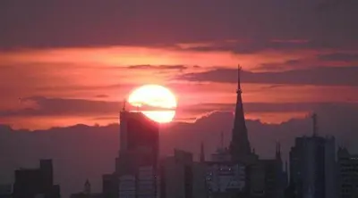a sunset over a city with the sun in the sky at Aquí Tu Apartamento Tranquilo in Manizales