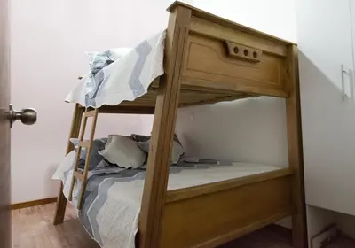 a bunk bed in a small room with a bunk bedutenewayangering at Beautiful Modern House in Guatape! in Guatapé