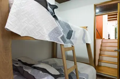 a bunk bed with a pillow on a ladder at Beautiful Modern House in Guatape! in Guatapé