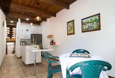 a kitchen and dining room with a table and chairs at Beautiful Modern House in Guatape! in Guatapé