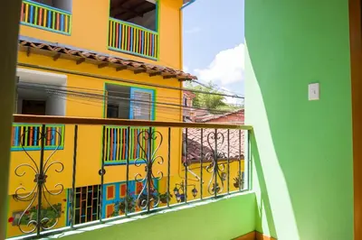 a balcony of a building with a yellow at Beautiful Modern House in Guatape! in Guatapé