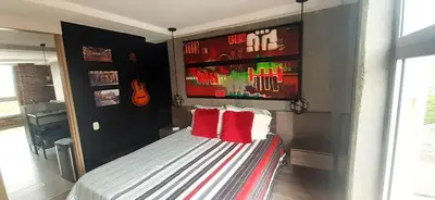 a bedroom with a bed with two red pillows at Stylish Loft in Laureles-Gorgeous views & comfort in Medellín