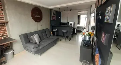 a living room with a couch and a table at Stylish Loft in Laureles-Gorgeous views & comfort in Medellín