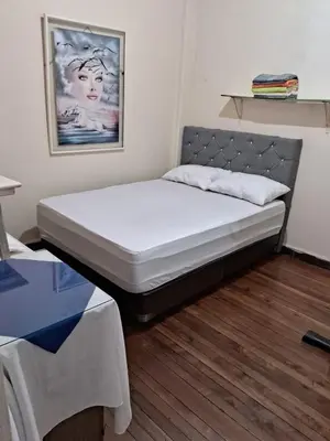 a bed sitting in a room with at Hospedaje Parque Caldas Fundadores Manizales in Manizales