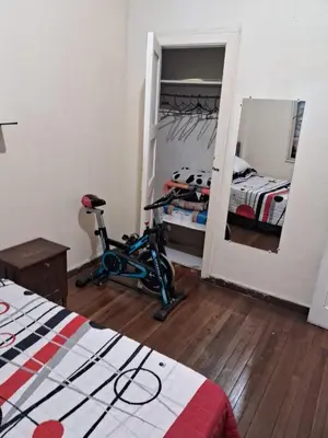 a bedroom with a exercise bike and a mirror at Hospedaje Parque Caldas Fundadores Manizales in Manizales