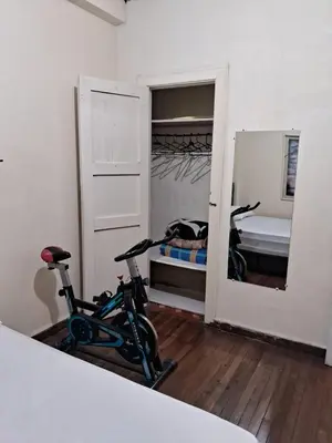 a room with a bike and a bedroom with a bed at Hospedaje Parque Caldas Fundadores Manizales in Manizales