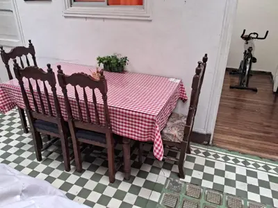 a table with a red and white checkeredkered floor at Hospedaje Parque Caldas Fundadores Manizales in Manizales