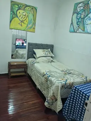 a bedroom with a bed and a mirror at Hospedaje Parque Caldas Fundadores Manizales in Manizales