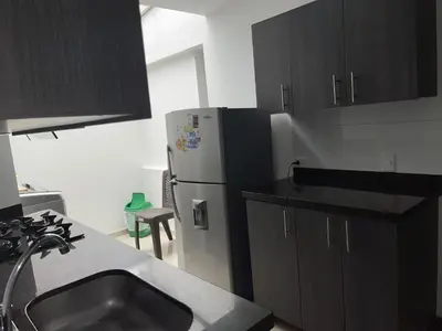 a kitchen with a sink and a refrigerator at Apartamento familiar laureles 203 in Medellín