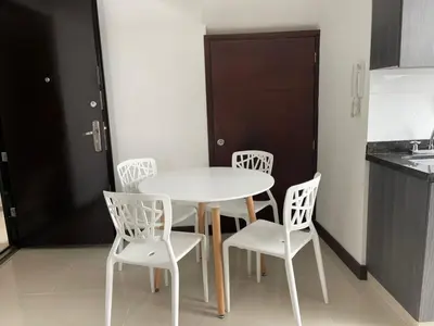 a white table and chairs in a kitchen at Apartamento familiar laureles 203 in Medellín