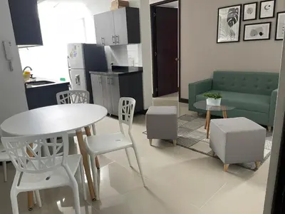 a kitchen and living room with a table and chairs at Apartamento familiar laureles 203 in Medellín