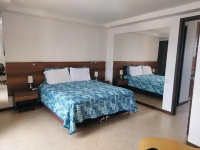 a bedroom with two beds and a large mirror at Penthouse Rooftop terrace Gem in the sky-Laureles in Medellín