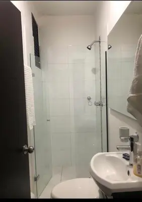 a bathroom with a shower and a toilet and a sink at Apartamento con balcón y hamaca en zona rosa laureles 301 in Medellín