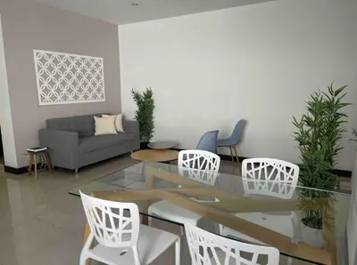 a living room with a glass table and white chairs at Apartamento con balcón y hamaca en zona rosa laureles 301 in Medellín