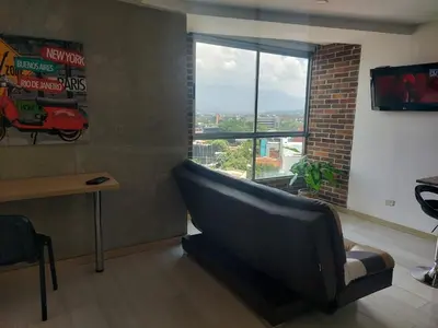 a waiting room with a couch and a window at Best views in town, 14th floor Laureles Gem in Medellín