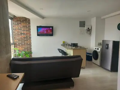 a living room with a couch and a kitchen at Best views in town, 14th floor Laureles Gem in Medellín