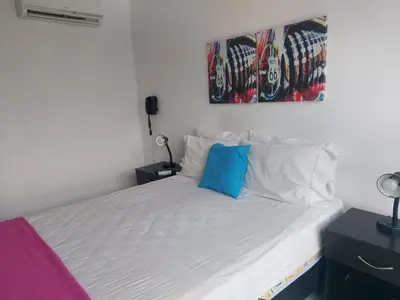 a bedroom with a bed with a blue pillow on it at Best views in town, 14th floor Laureles Gem in Medellín