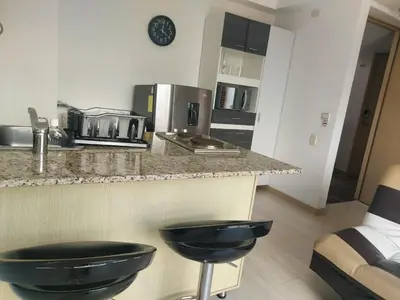 a kitchen with a counter with two black stools at Best views in town, 14th floor Laureles Gem in Medellín