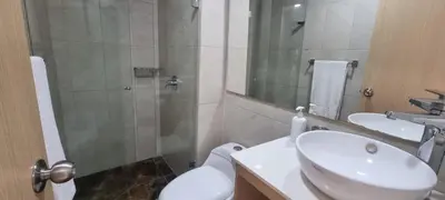a bathroom with a toilet and a sink and a shower at Laureles Deluxe Apartment in the Medellin sky in Medellín