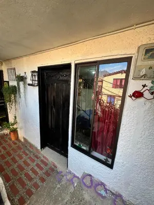 a front door of a house with a window at Aparta estudio comuna trece in Medellín
