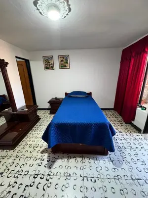 a bedroom with a blue bed in a room at Aparta estudio comuna trece in Medellín