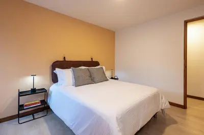 a bedroom with a large white bed with two pillows at Cómodo y recién remodelado apto de 2 habitaciones cerca a Provenza in Medellín